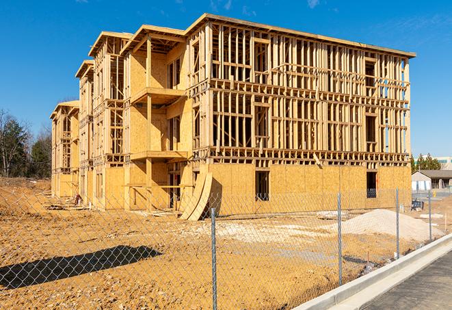 a close-up of temporary chain link fences enclosing a construction site, signaling progress in the project's development in Vacaville